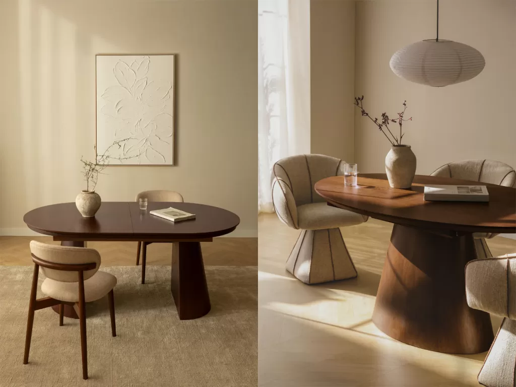 Tavola da pranzo moderna decorata con vaso geometrico e libri d'arte impilati.