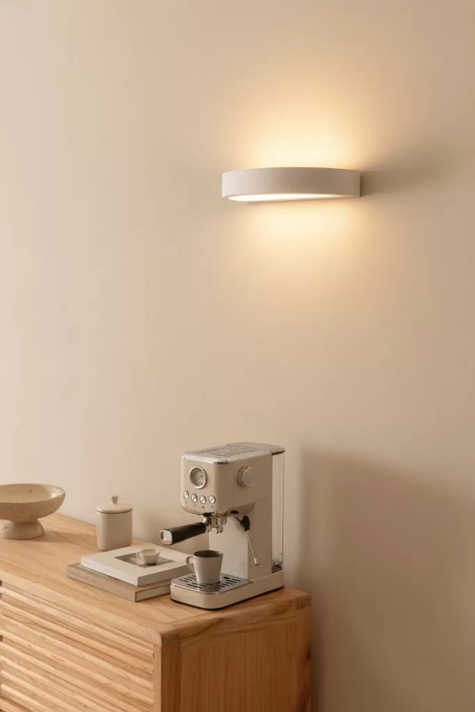 Aplique de pared sobre estación de café en mueble de madera; iluminación cálida para decorar un rincón para el café